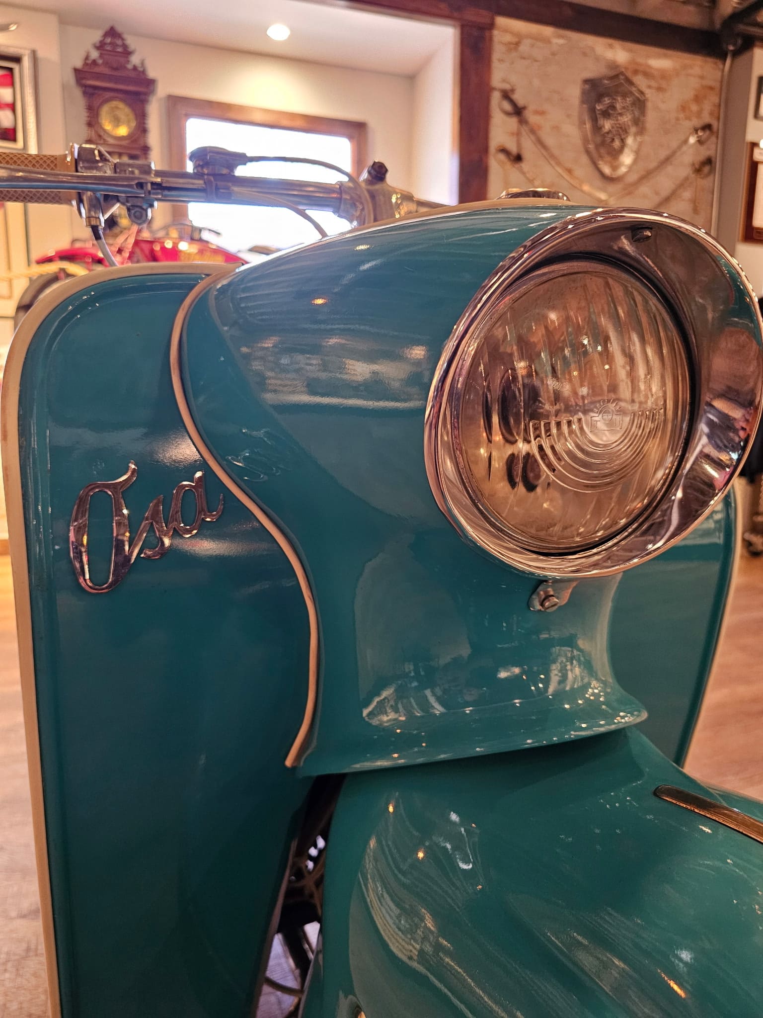Chrome Osa script on the leg shield beside the headlamp